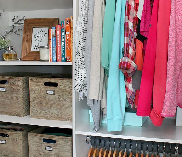 Organized closet with clothes arranged by color.