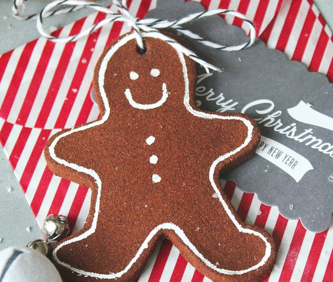 Cinnamon ornament gingerbread man used as a present topper.