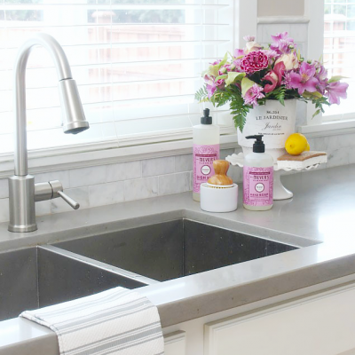 Farmhouse style organized kitchen with pretty sink display.