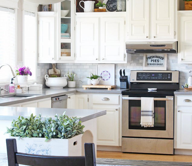 White farmhouse style kitchen with quartz countertops.