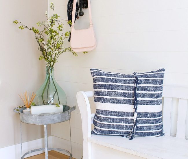 Farmhouse style front entry way decorated for spring.