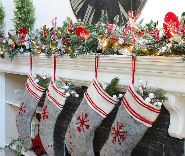 Christmas mantel with flocked garland, felted wool stockings, and traditional Christmas colors.