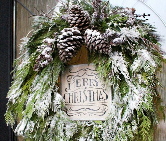 Christmas wreath made from fresh greenery and topped with flocking.