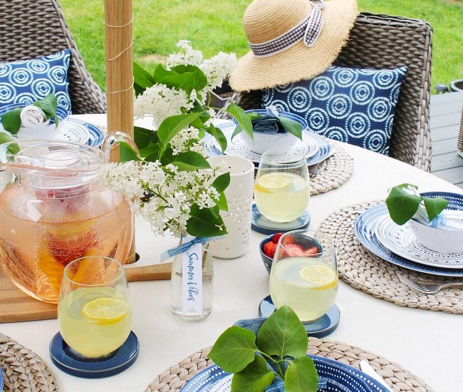 Simple summer entertaining idea. Summer tablescape using blues and whites with fresh flowers and greenery.