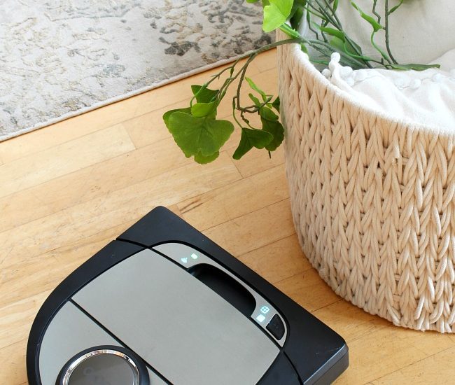 Neato D7 robotic vacuum on a hardwood floor.