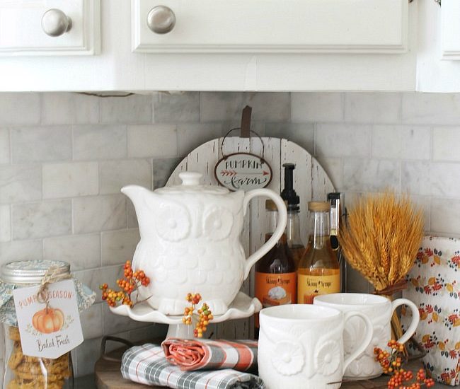 Fall beverage bar with owl tea set and flavored syrups.