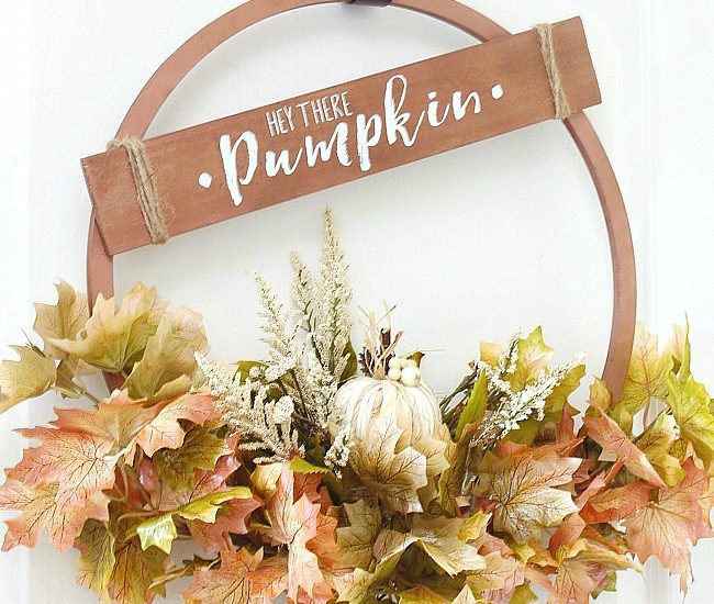 Beautiful copper hoop wreath for fall with 'Hey There Pumpkin' sign.