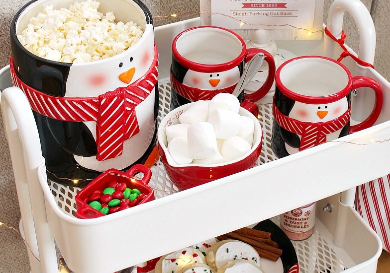 Christmas movie night cart with popcorn, hot chocolate and Christmas treats.