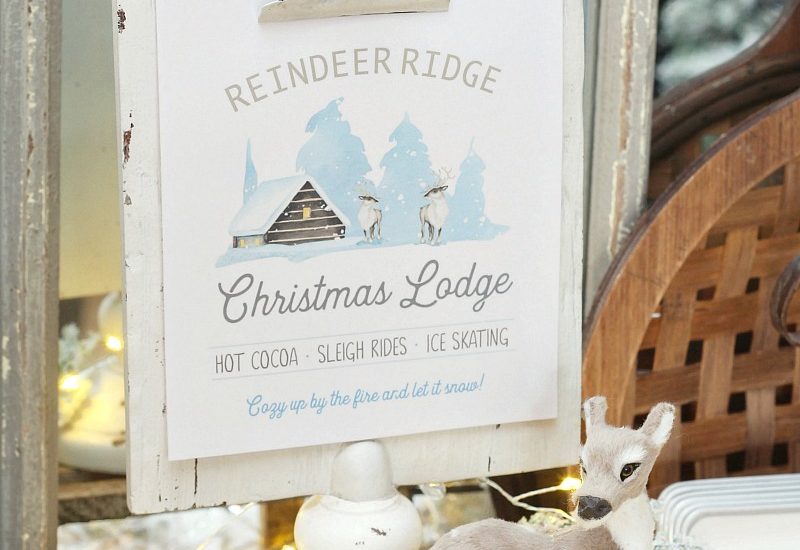 Reindeer Ridge Christmas Lodge free printable on a white clipboard frame with reindeer and twinkle lights.