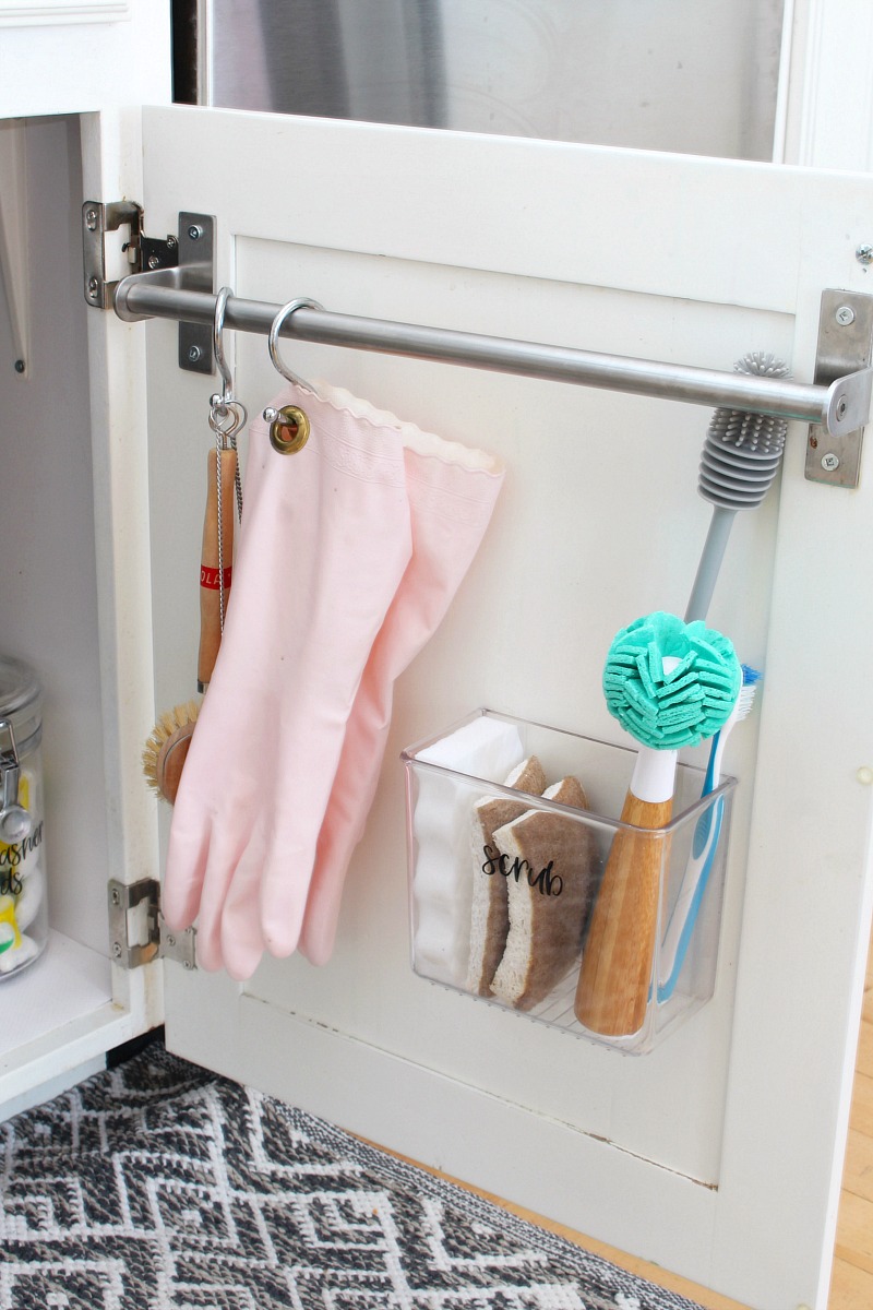 Inside of kitchen cupboard used for extra storage for cleaning products.