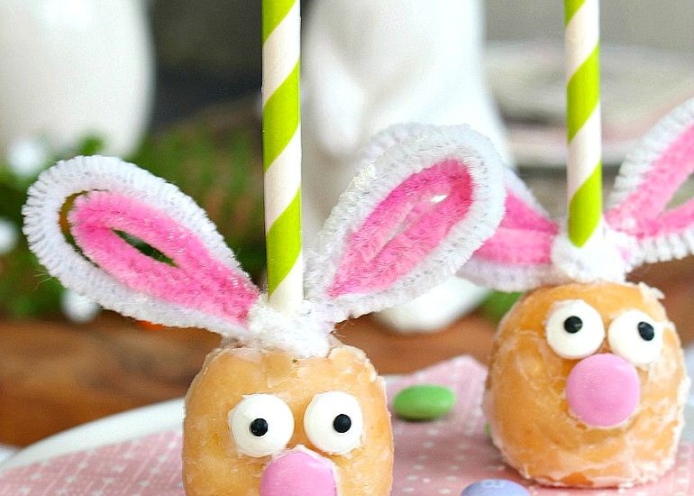 Cute Easter bunny donut holes on a cake stand.