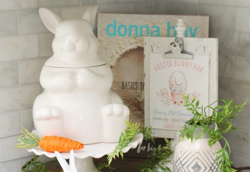 Wood tray with Easter kitchen decor items in a white kitchen.