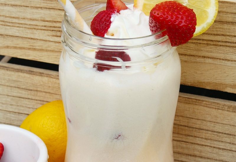 Strawberry lemonade float with fresh strawberries and lemonades.