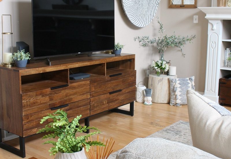 Modern farmhouse style family room with wood television console.