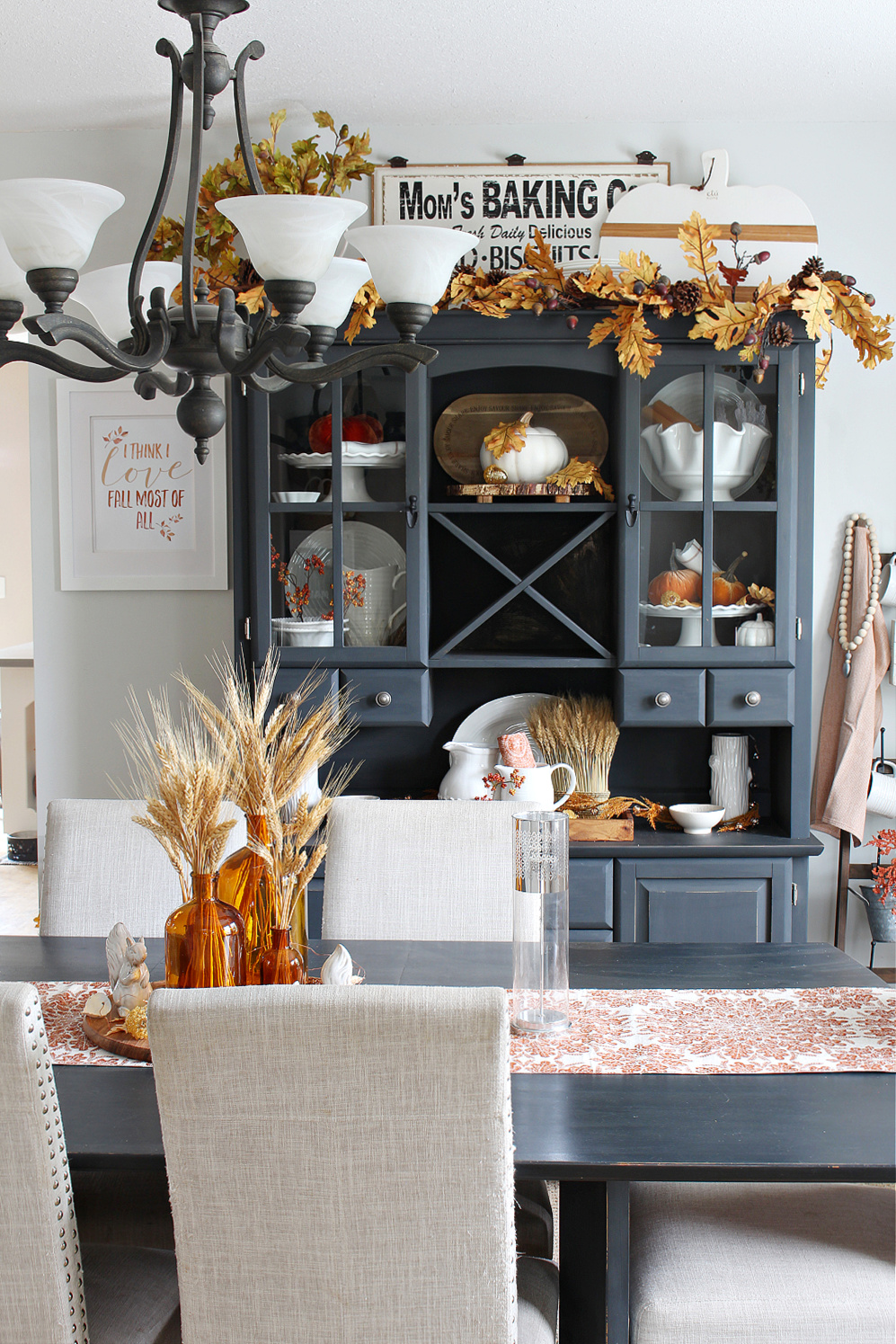 Dining room with black furniture decorated for fall.