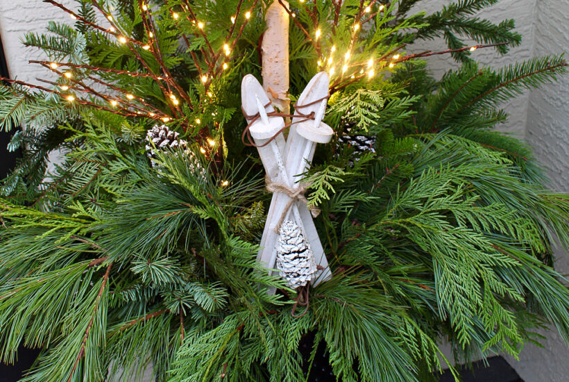 Christmas front porch with beautiful outdoor Christmas planters.