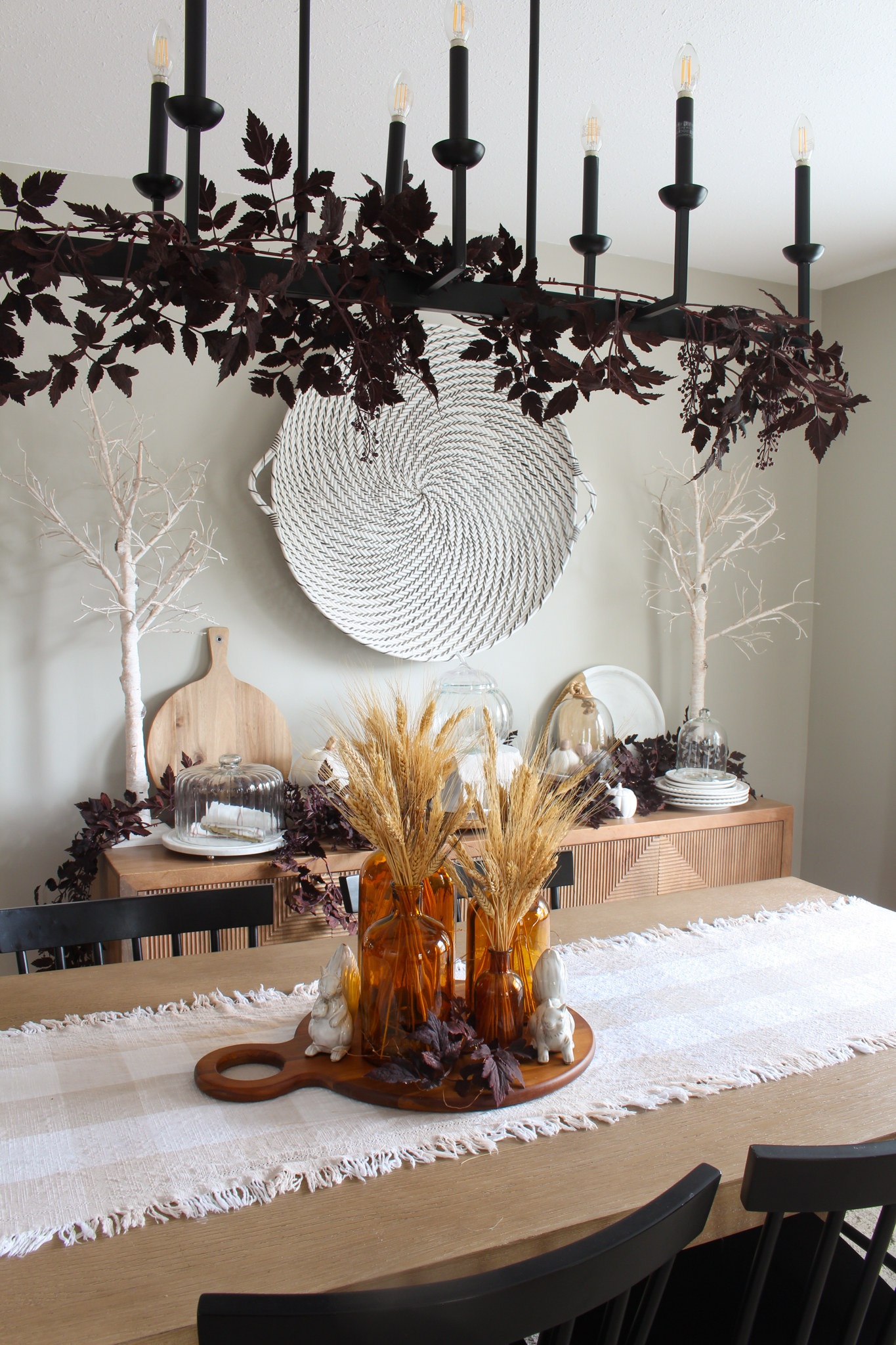 Fall dining room table with amber glass and wheat centerpiece.