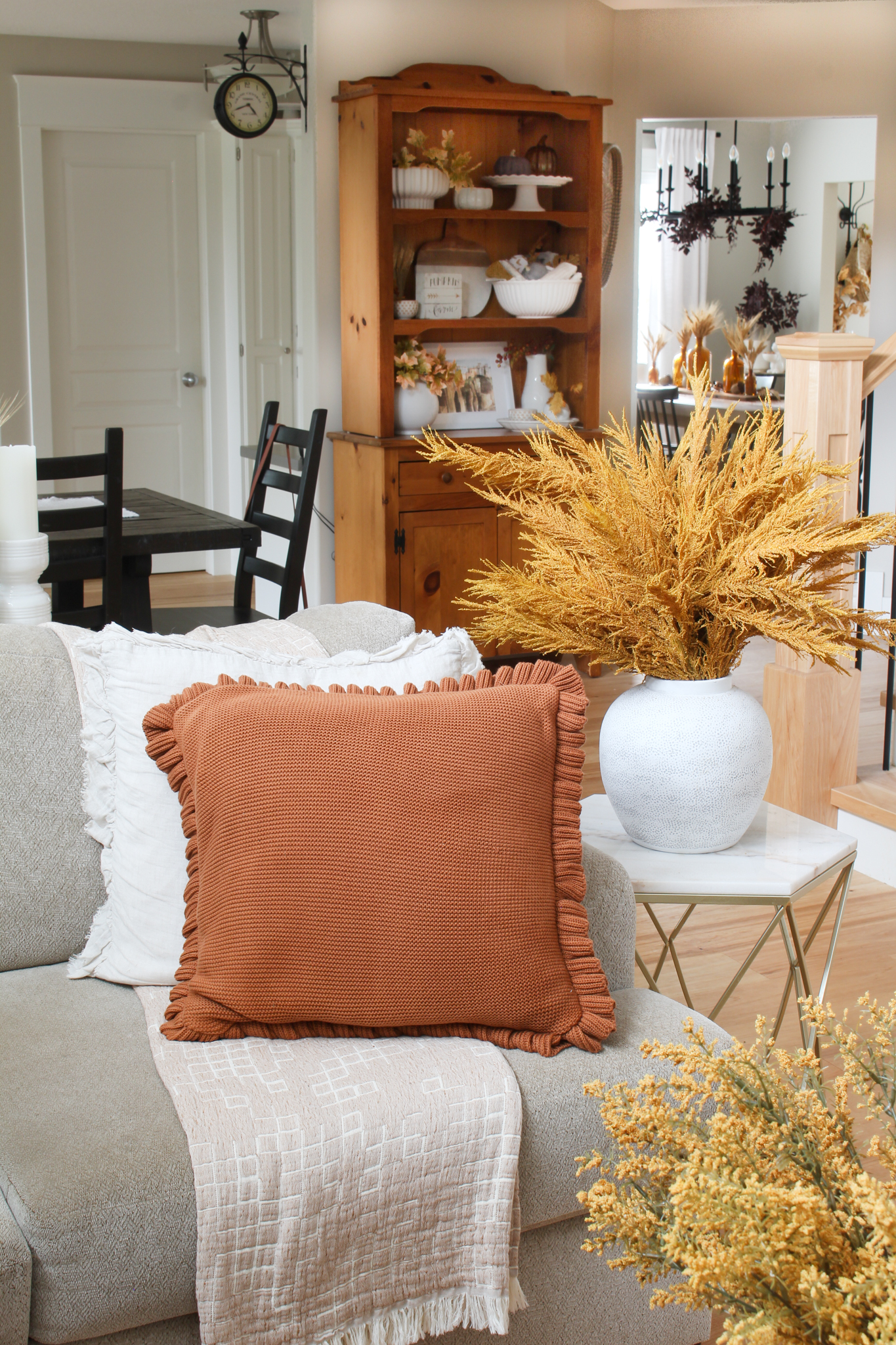 Fall living room sofa with cozy knit pillows.