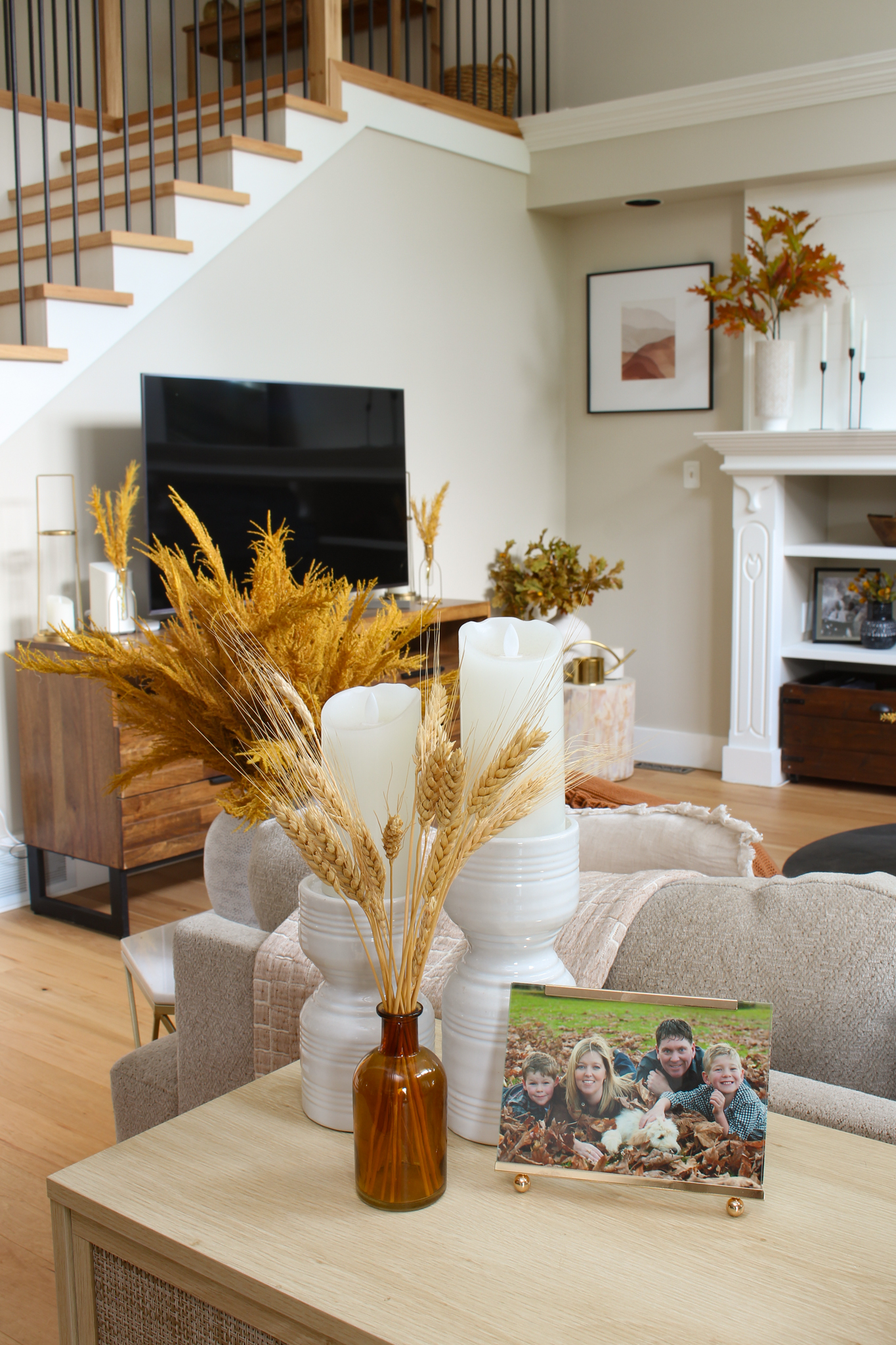 Fall living room with pops of yellow using wheat and fall stems.