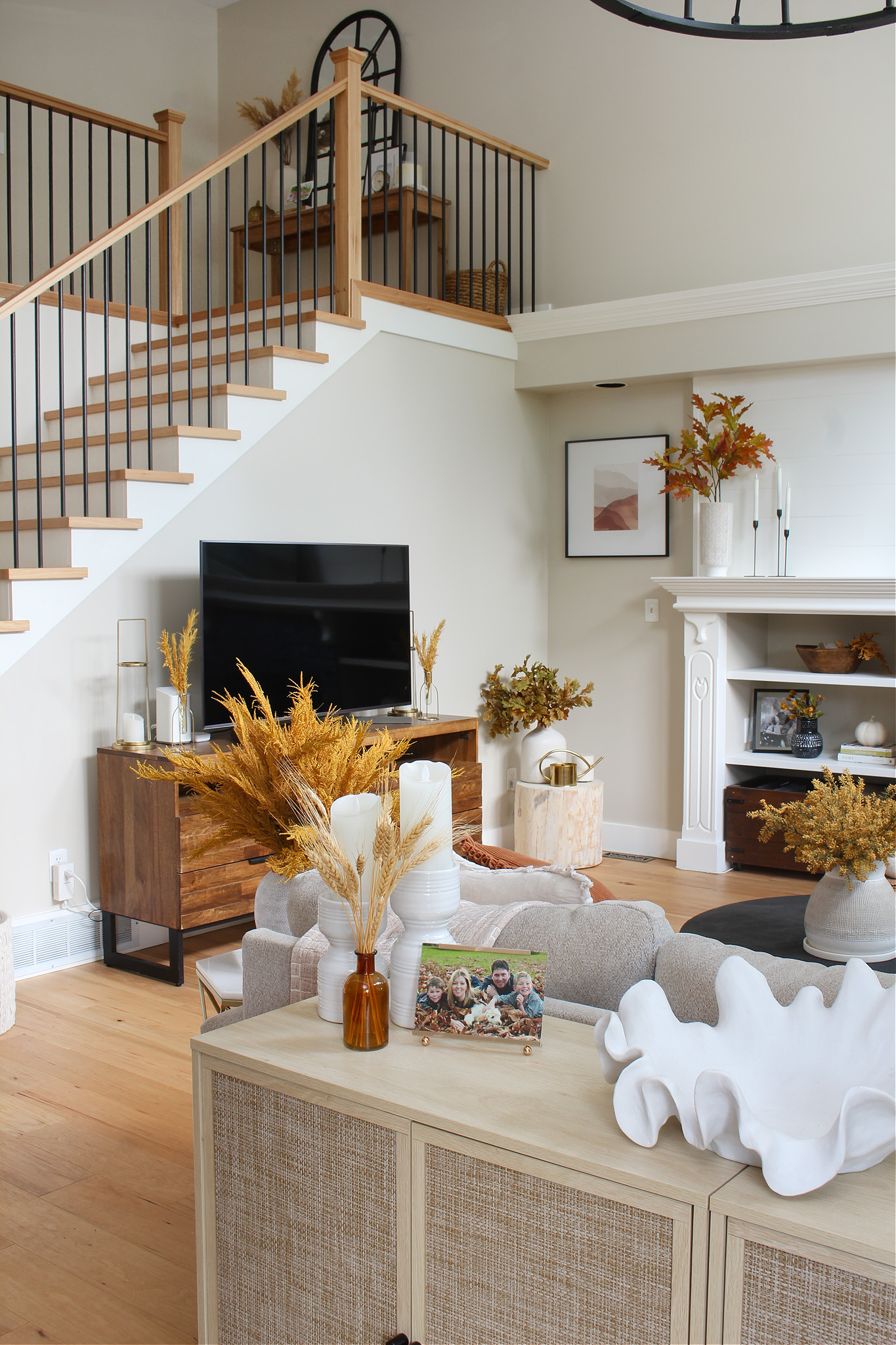 Neutral fall living room decorated for fall with yellows, amber, and rust colors.