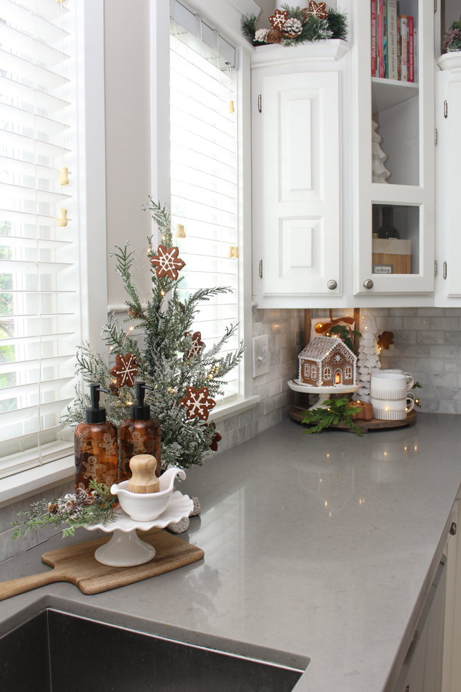 White kitchen decorated for Christmas with a gingerbread inspired theme.