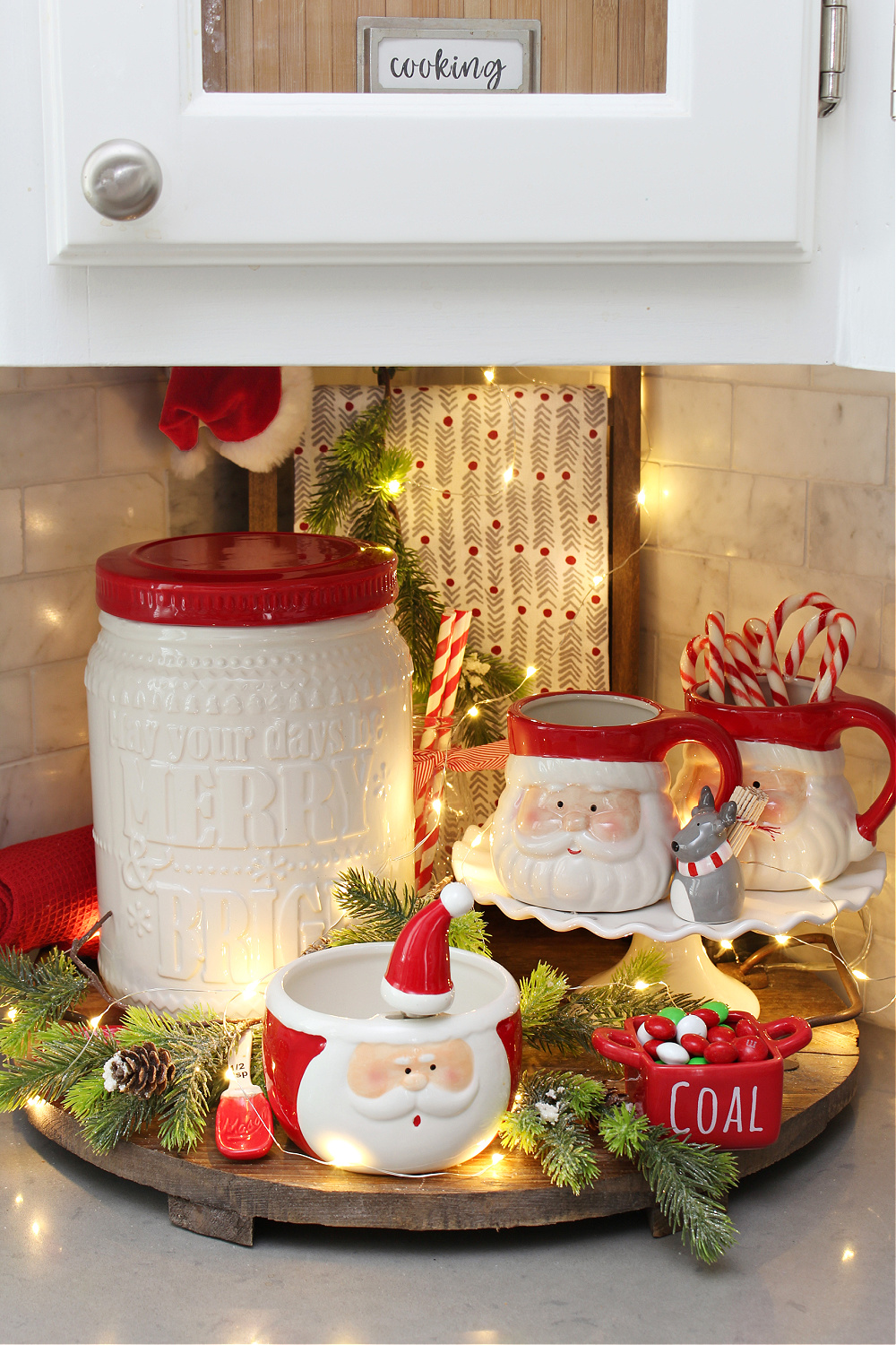 Wooden tray decorated for Christmas with cookie jar and Santa mugs.