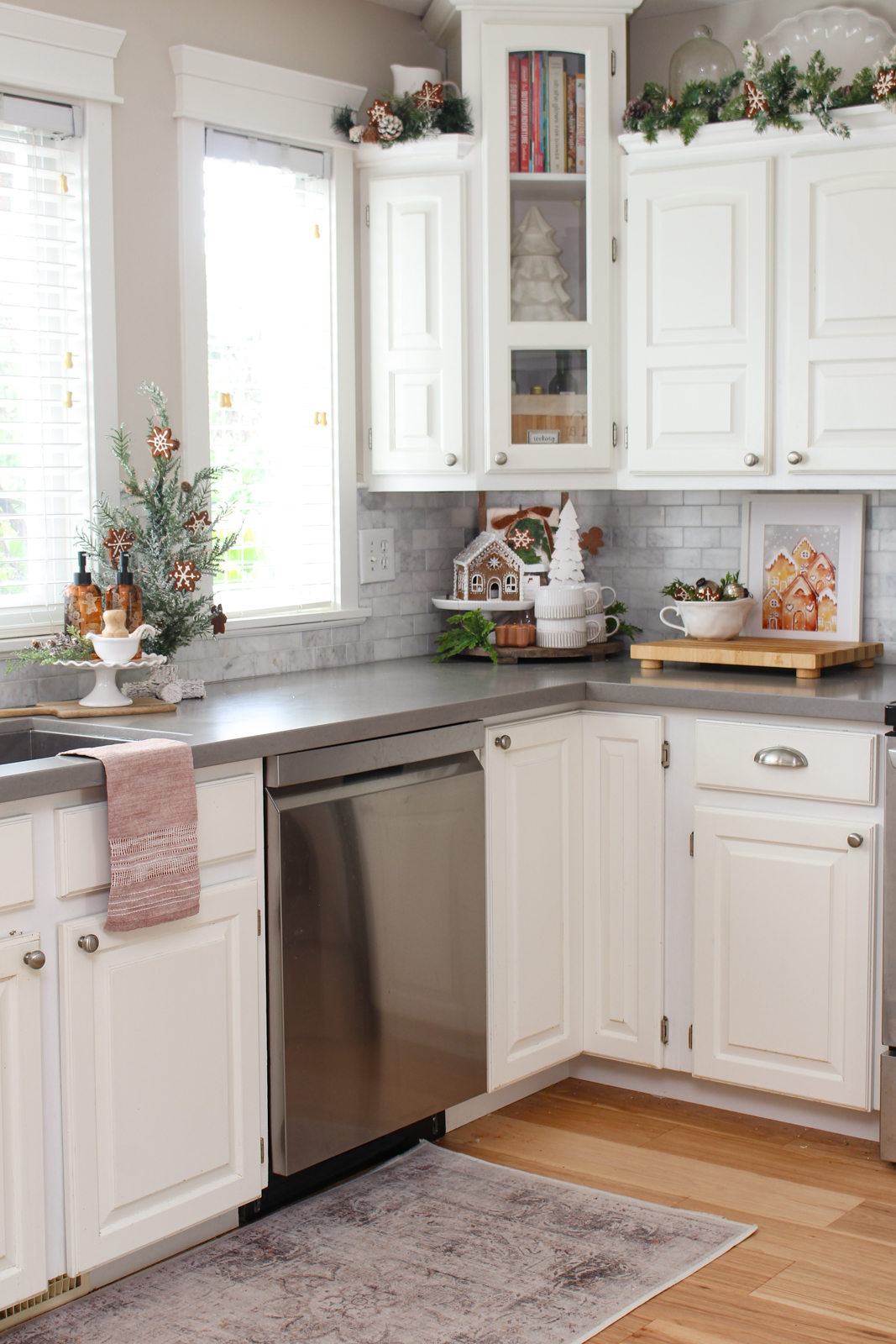 White kitchen decorated for Christmas with a gingerbread inspired theme.