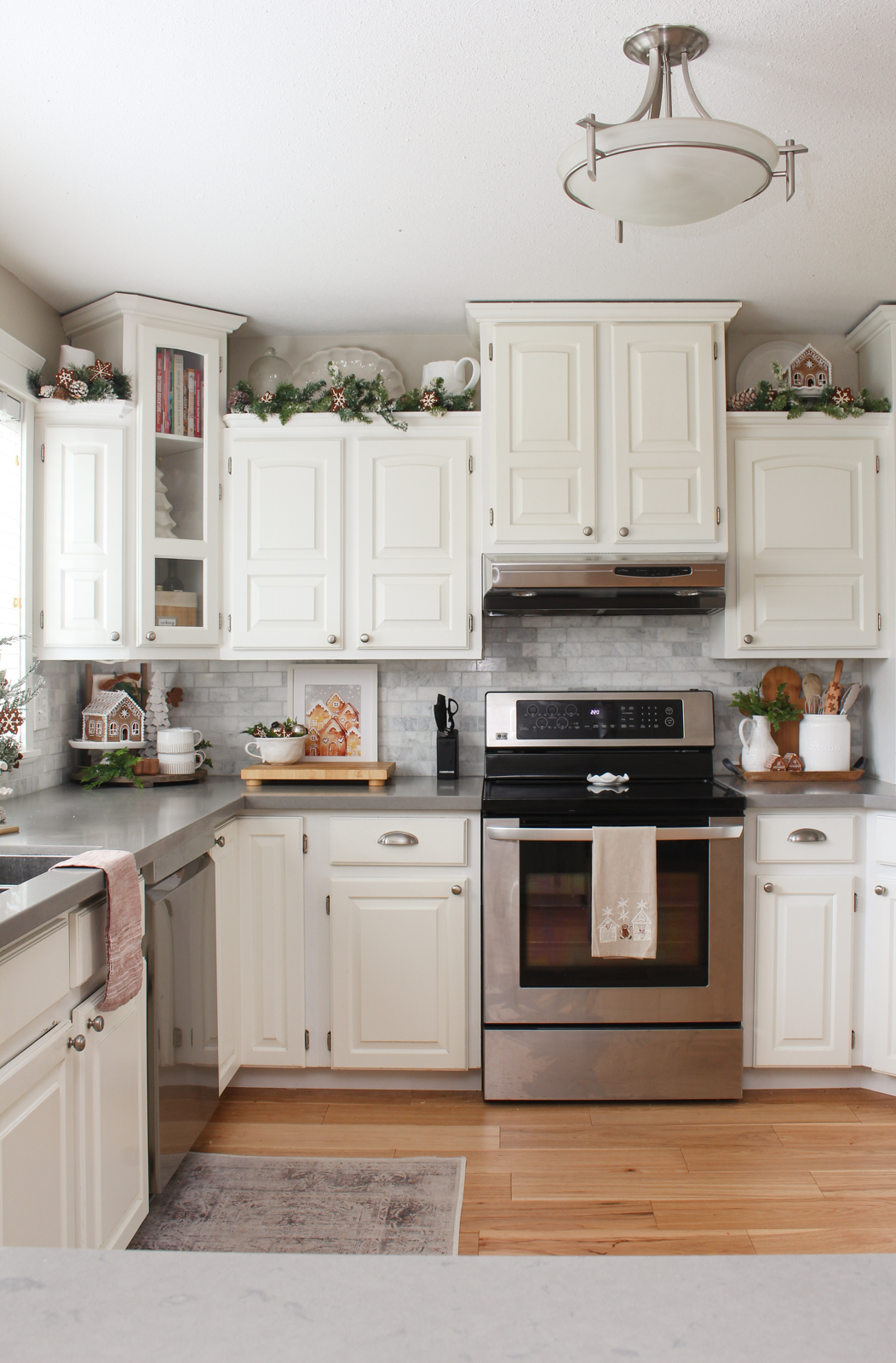 White kitchen decorated for Christmas with a gingerbread inspired theme.